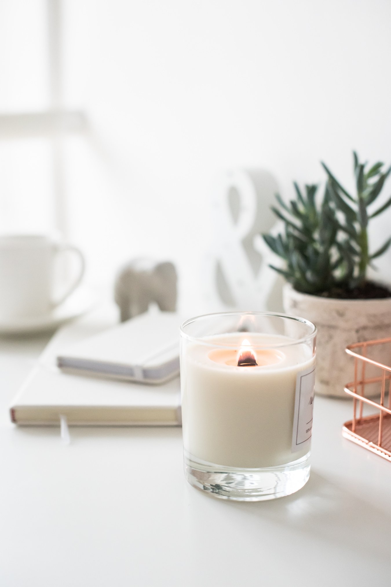 White Burning Candle on Table